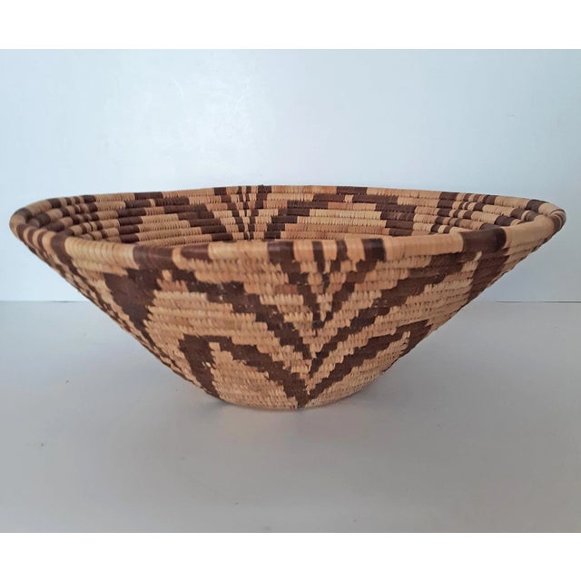 African Tribal style hand woven coil basket with star flower pattern. Natural color with various shades of brown and tan...