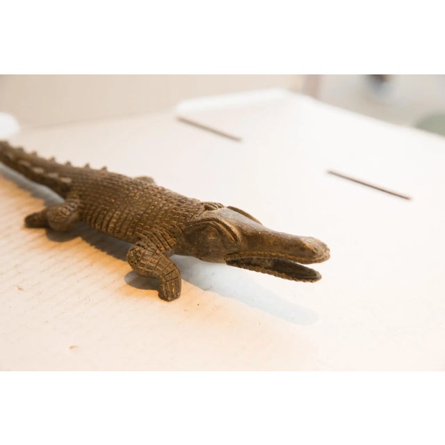 :: Vintage handmade African crocodile sculpture. Circa late mid 20th century, though possibly older, this piece has such...