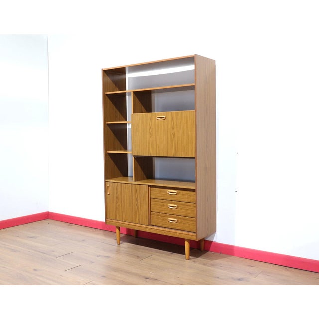 A fabulous room divider made by renowned furniture maker Schreiber, this Mid Century Modern vintage display cabinet offers...