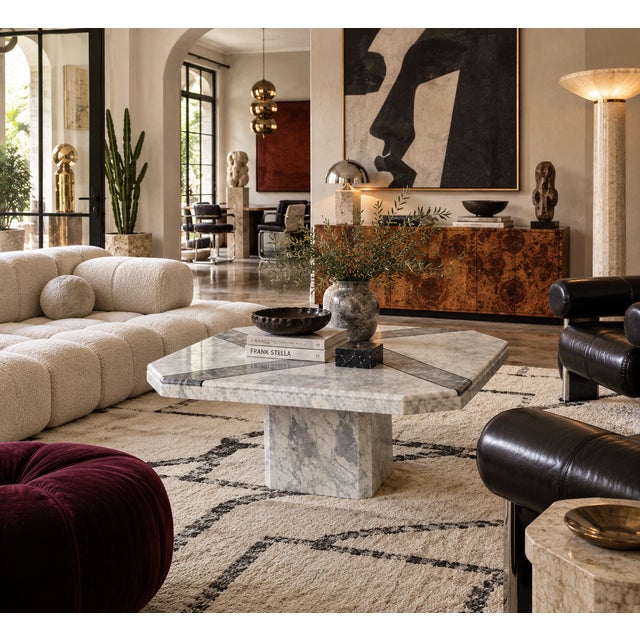 A geometric vintage marble coffee table from Italy, with white Carrara and grey Bardiglio marble pieced together across...