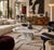 A geometric vintage marble coffee table from Italy, with white Carrara and grey Bardiglio marble pieced together across...