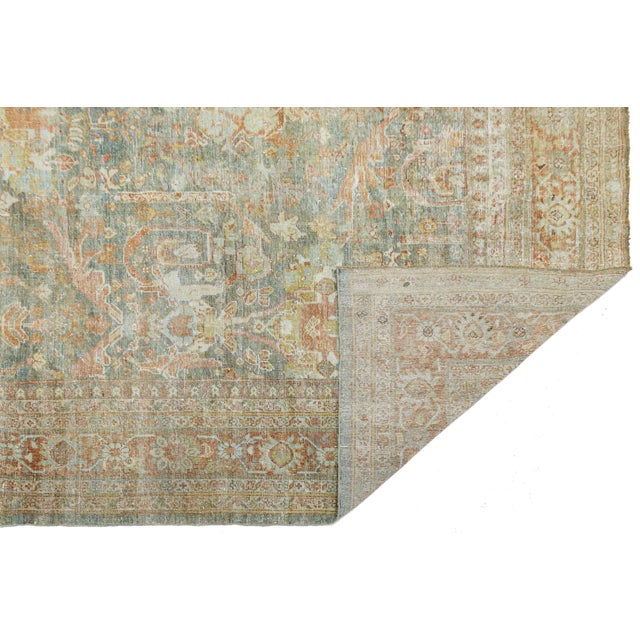 Elevate your space with timeless elegance. Hand-knotted from soft, high-quality wool, this authentic Antique Mahal rug...
