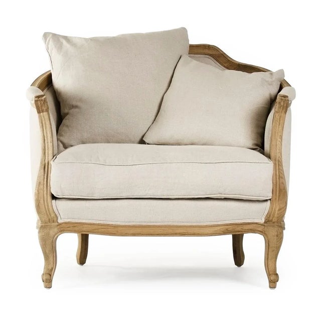 Curved back love chair upholstered in natural linen on natural oak frame.