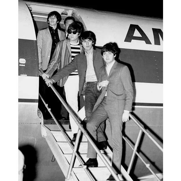 The Beatles Arriving Awesome capture of the Beatles arriving at their destination, stepping off of a private plane. The...