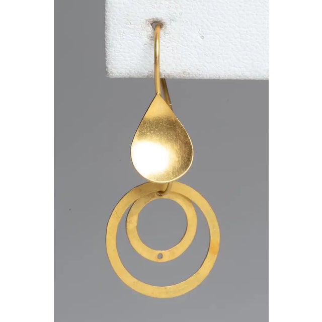 22K gold drop earrings with a matte finish. Circles with circles with spade-shape French wire for pierced ears. The fine...