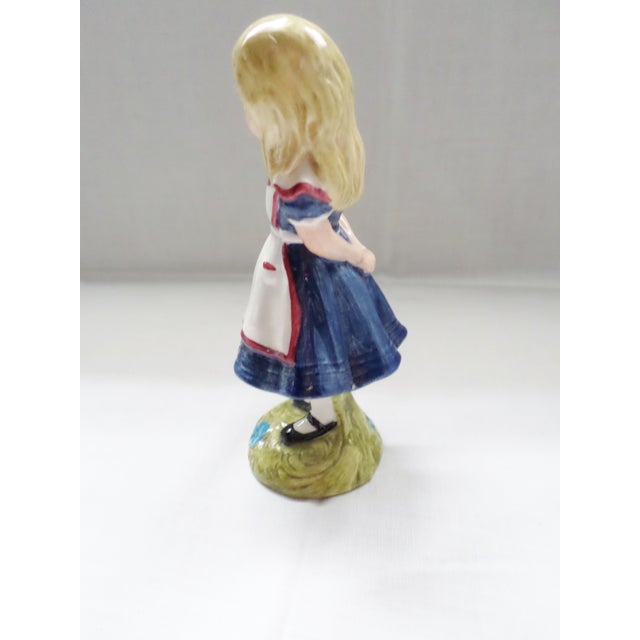 The vintage Alice figurine from Beswick, made by Royal Doulton in 1974, is a charming collectible celebrating the iconic...