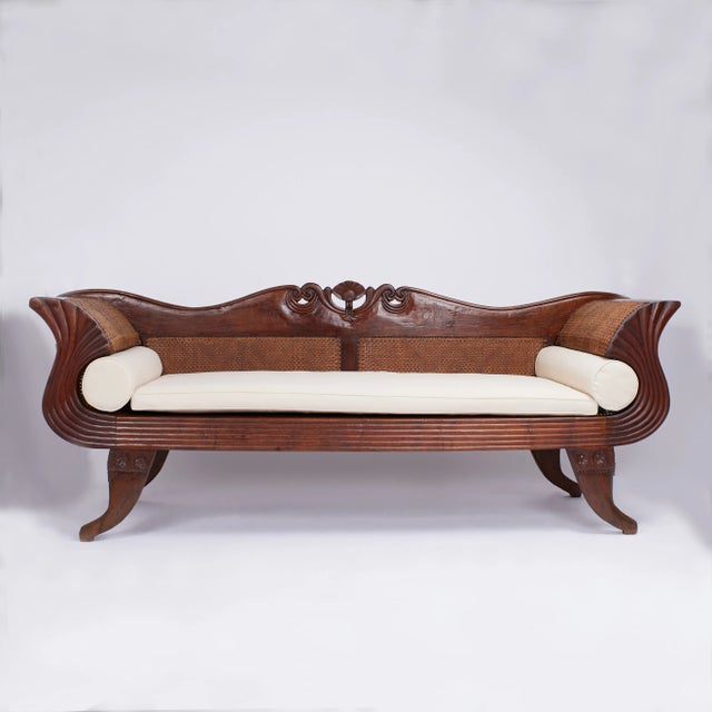 Rare and unusual 19th Century Anglo Indian sofa handcrafted in teak with pegged construction featuring a rolled crest with...