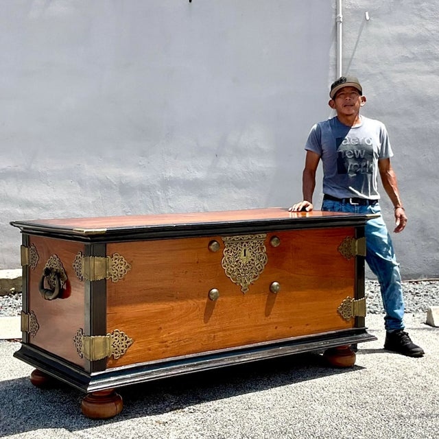 A spectacular vintage Boho blanket chest. Monumental in size and drama. A beautiful ebony and mahogany cabinet with...