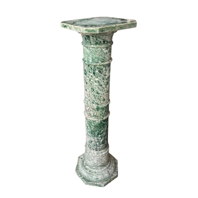An early 20th century green variegated marble column with reeded bands and octagonal base. Measures 39” tall x 11.75” wide...