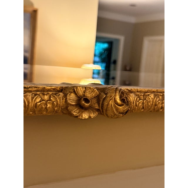 Grand Gilt Mantle Mirror Baroque style large git mirror with scrolls and floral motifs. Believed to be Maitland Smith but...