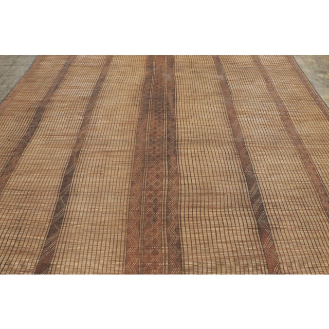 This vintage Moroccan mat is a primitive 10x12 Tuareg work from the nomadic tribe of the same name. Handwoven with reeds...
