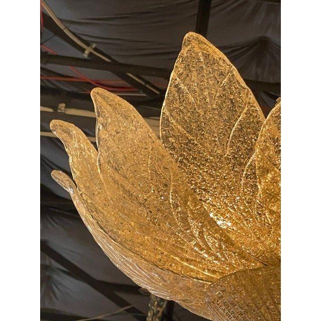 The Murano Gold Granola Glass Leaf Form Flush Mount Chandeliers are stunning ceiling fixtures that add a touch of elegance...