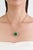 This statement pendant necklace features 18.82 carat emerald-cut emerald, set in 14k yellow gold. The center stone...