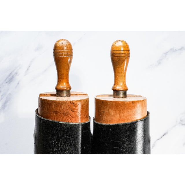 Add a striking touch of equestrian heritage to your home with this impressive pair of antique English black leather riding...