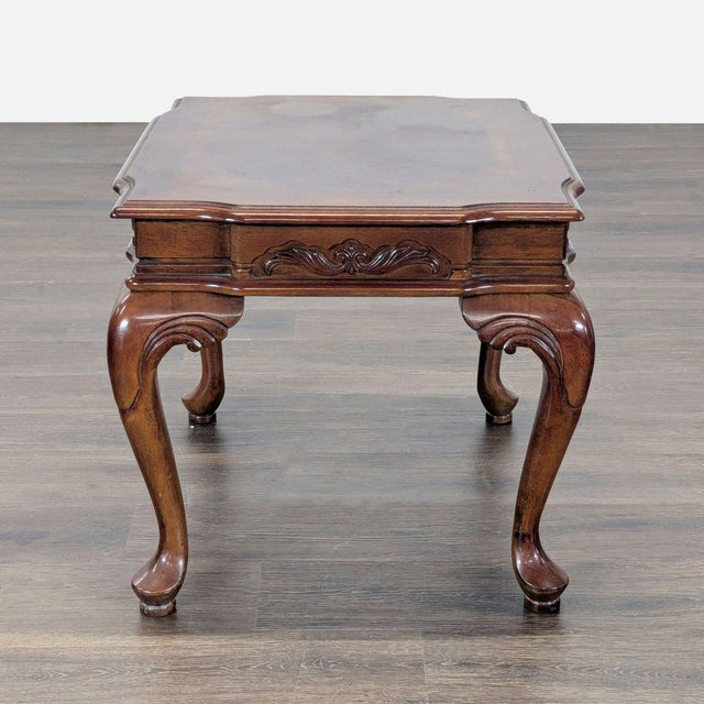 Carved table with cabriole legs and inlaid top. Dimensions (in): 23W x 28D x 21H.