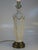 This French Empire Style Neoclassical table lamp is a vintage piece made of porcelain with a luxurious gold color and...