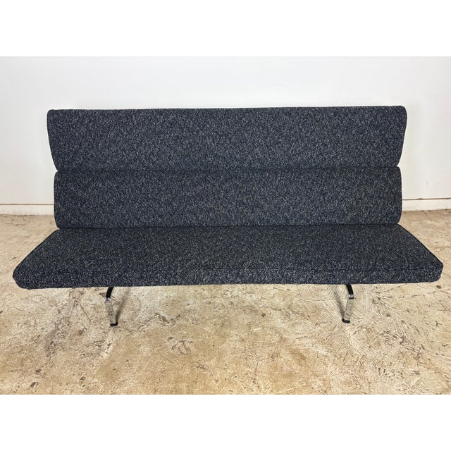 Original Eames compact sofa. This has been reupholstered with a navy/black/white boucle fabric. Charles and Ray Eames...