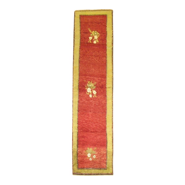 excellent condition hand-knotted Turkish Tulu Runner in bright red and green accents from the middle of the 20th century....
