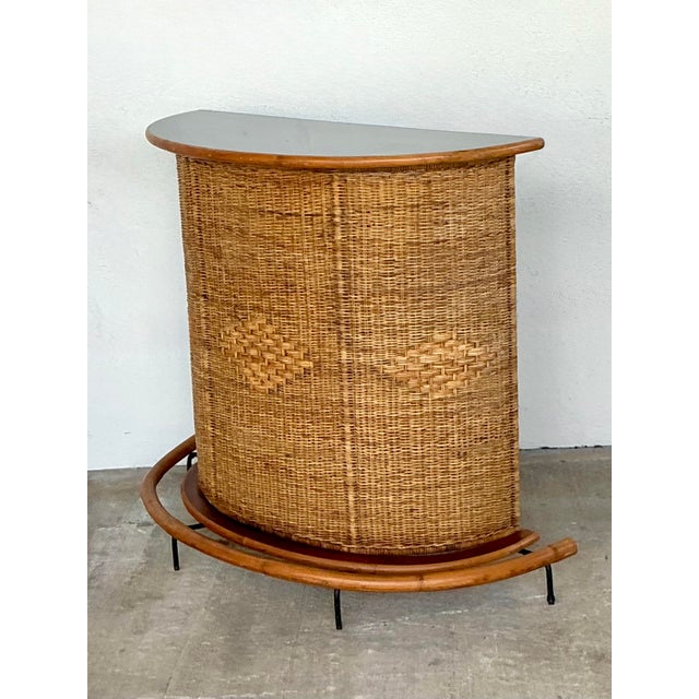 This Vintage Diamond Weave Dry Bar is a masterful expression of 1970s coastal design and artisanal wickerwork. Its semi-...