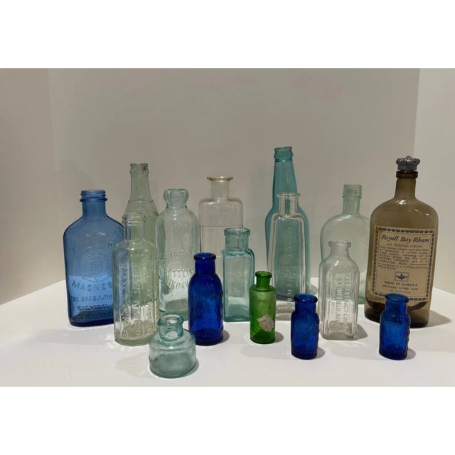 Curated group of authentic antique apothecary and drugstore bottles dating primarily to the late 19th and early 20th...