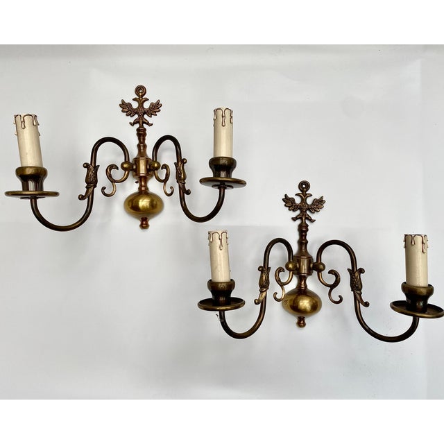 This striking pair of vintage brass sconces, from Belgium, 1970s, commands attention with their impressive size and unique...