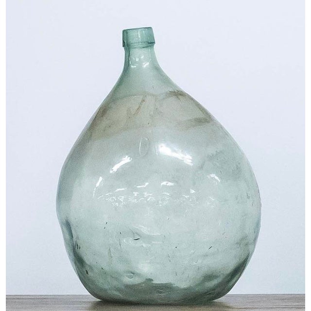 From Spain from the 19th century Originally used to storage liquid, probably wine. The glass has bubbles, beautiful mark...