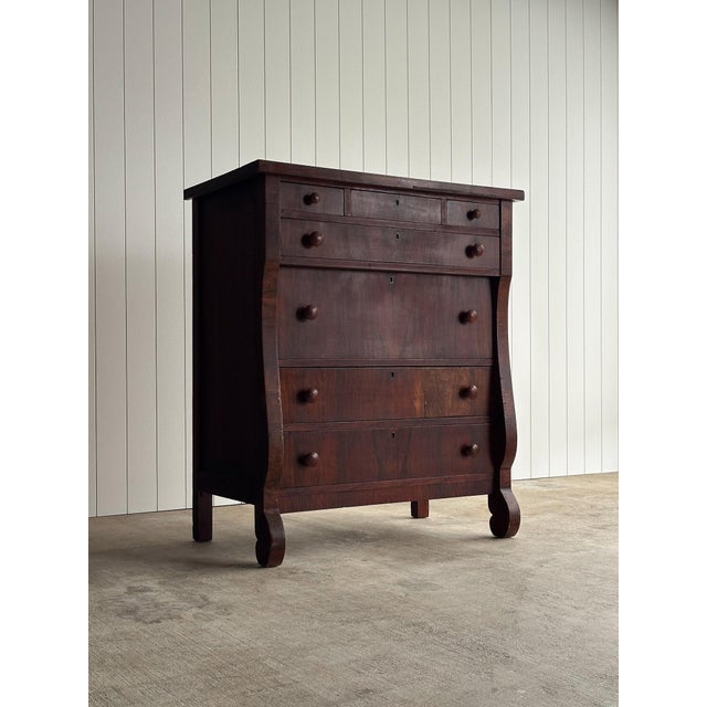 Antique chest of drawers in figured veneer with three small drawers over four full-width drawers. Original turned wood...