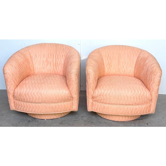 Pair of Diminutive 1970s Pink Silk Channel-Quilted Swivel Club Chairs These inviting low-profile swivel club chairs...