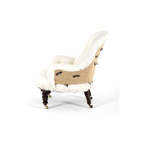 A generously proportioned over stuffed button back armchair in calico. Complemented with mahogany turned front legs and...