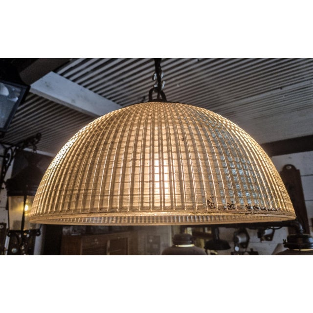 Large half-spherical Holophane suspension in molded glass, new electrification and ceramic socket (E27). This piece has an...