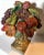 Vintage cast composite urn filled with fruit.