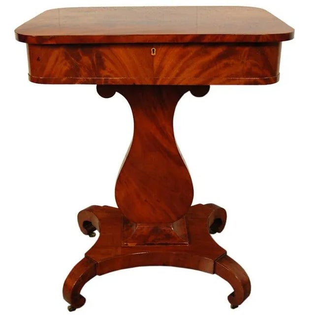 Magnificent crotch mahogany period Karl Johan (Biedermeier) lyre-shaped pedestal base table. Originally handcrafted as a...