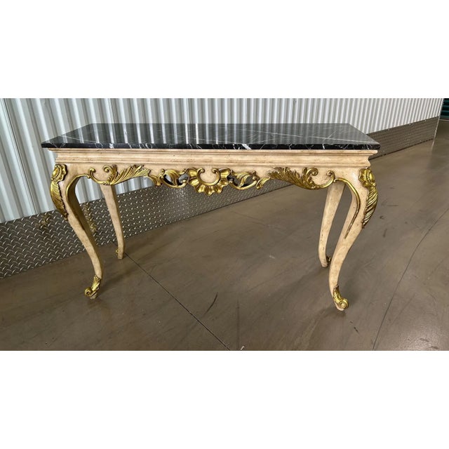 This is a light wood rectangular console done is the Louis XV Style by Maitland Smith. The console has a central gilded...