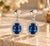 Radiating royal elegance and refined symmetry, these exquisite dangle drop earrings are crafted in solid 14K white gold....