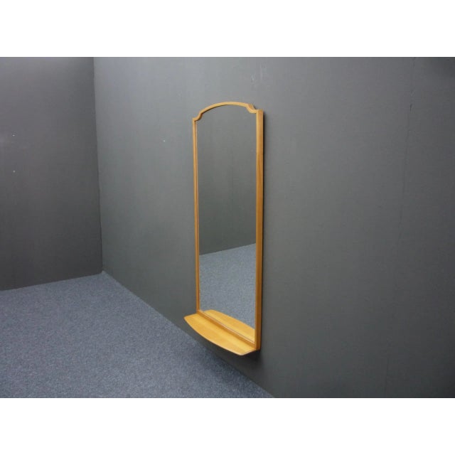 Nice wall mirror from the fifties. Very decorative and made of cherry wood. Mirror surface looks very good. Overall in...