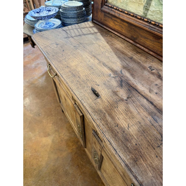 French 19th c bleached buffet with brass hardware. Three drawers over two doors. Top has a small slit for monetary...