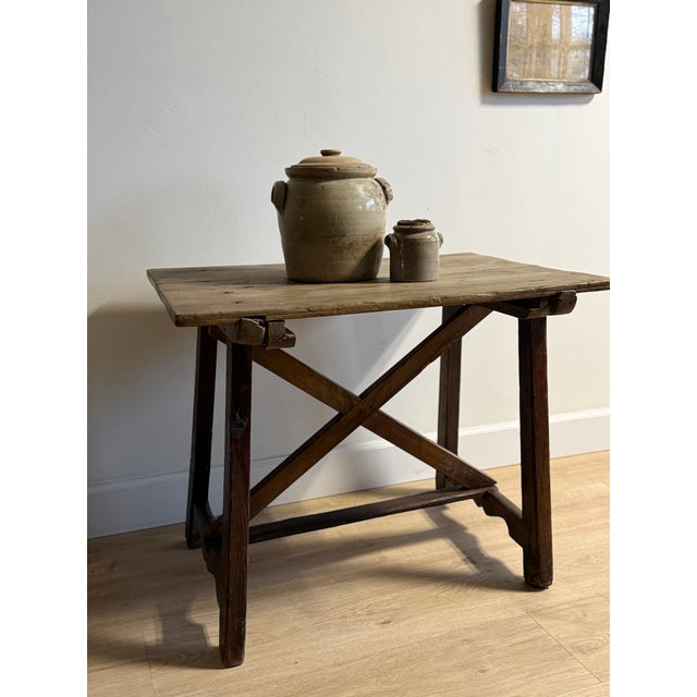 An incredible 18th-century Spanish accent table with a beautifully worn pine top and rich walnut base joined in classic...