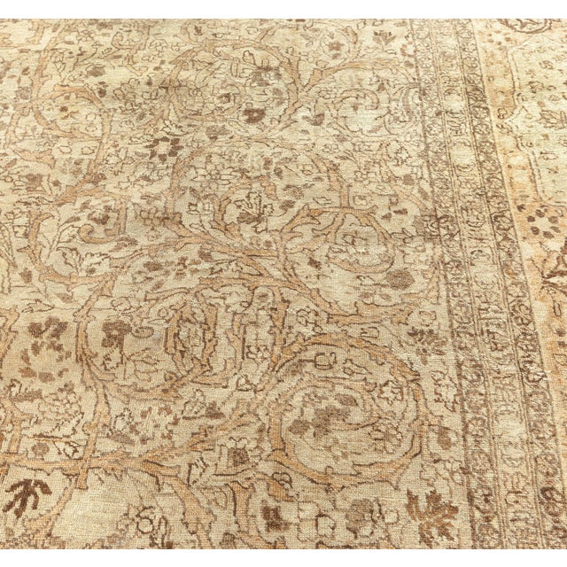 An early 20th century antique Persian Tabriz carpet, within an overall pattern of connected polychrome lozenges containing...