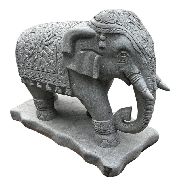 Amazing carved stone elephant statue from Indonesia. Intricate carvings of the traditional jhool (saddle cloth) and...