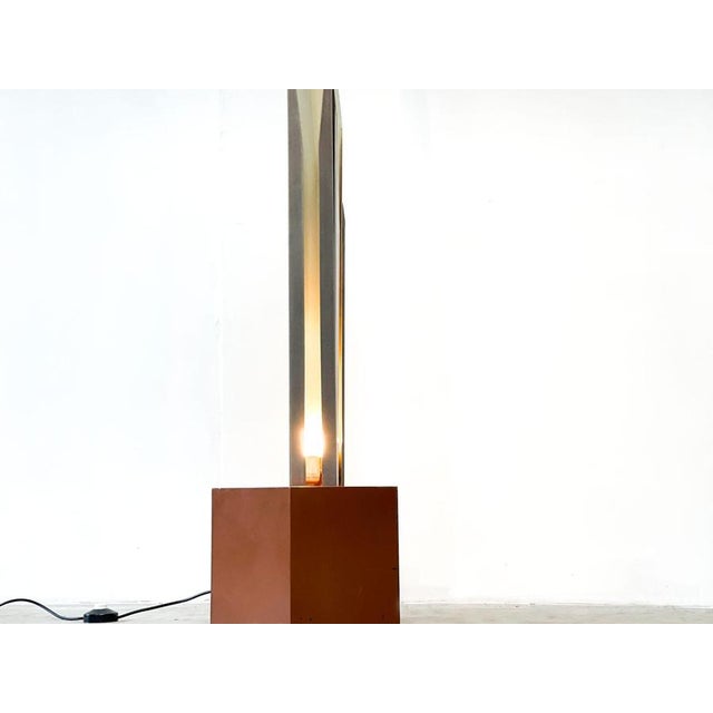 Striking vintage sculptural italian floor lamp. Its consists of three long aluminum 'shades' with a white metal finish...