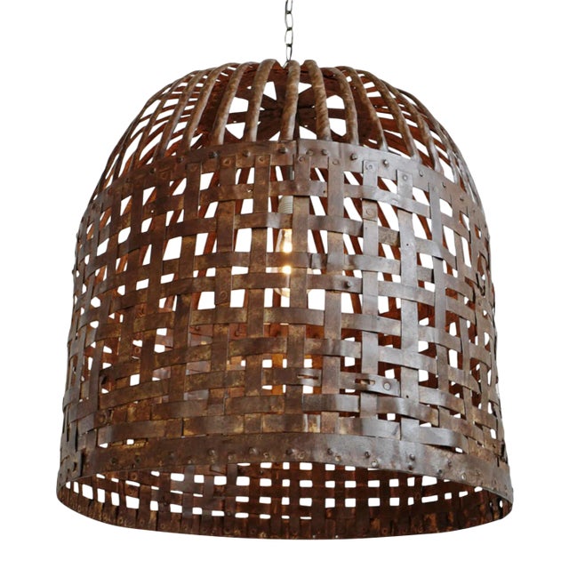 Vintage Indian iron cage basket thoughtfully repurposed into a one-of-a-kind pendant light, celebrating the raw beauty of...