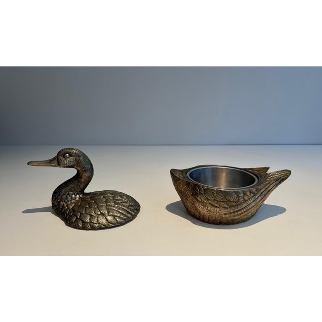 This lovely ice bucket depicting a duck is made of silver-plated metal. It is an Italian work signed by Mauro Manetti....