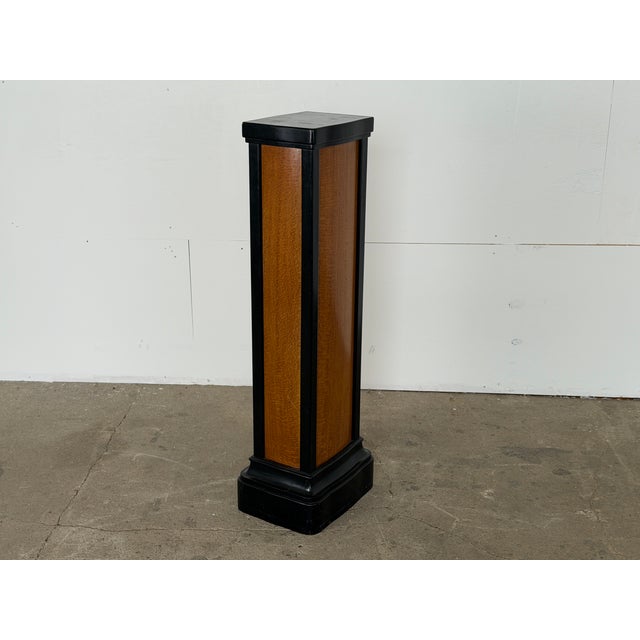 A figured wood and ebonised display pedestal in the Art Deco manner, European, 1930s. Each face is panelled in a single...