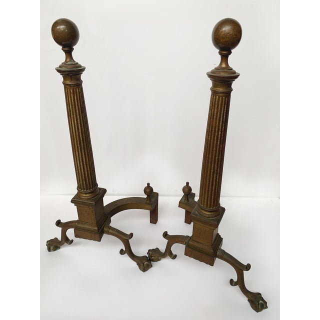 Made in France in the Late 19th Century, these tall brass andirons have ball finial tops and fluted column guards that...