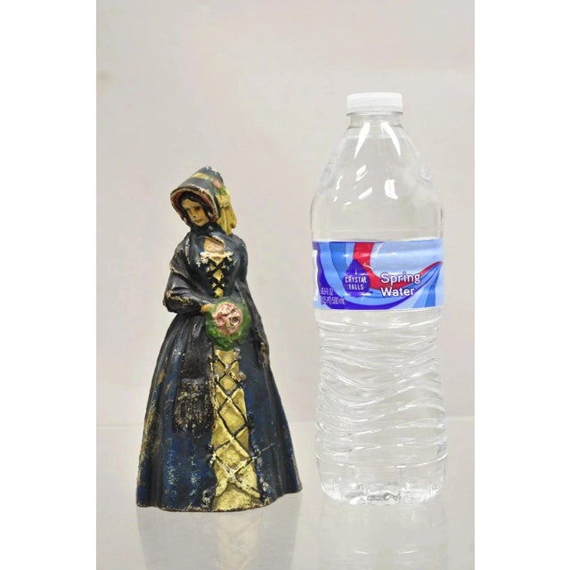 Antique Victorian Cast Iron Figural Colonial Woman in Blue Dress Painted Door Stop. Circa Early 20th Century....