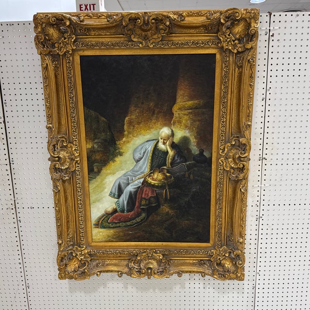 A framed vintage reproduction painting depicting Rembrandt’s famous masterpiece, Jeremiah Lamenting the Destruction of...