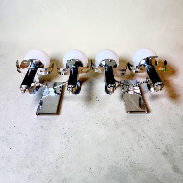 Pair of wall sconce lights that date back to the 1980s. Each of the lamps has 2 opaline glass lampshades. The sconces are...