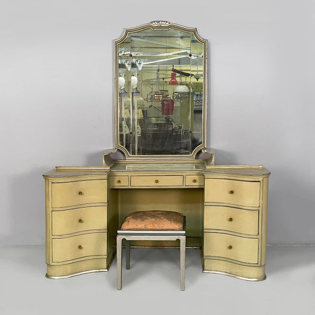 Wall console table with pouf. The upper section of the console features a shaped mirror framed in olive-green wood with...