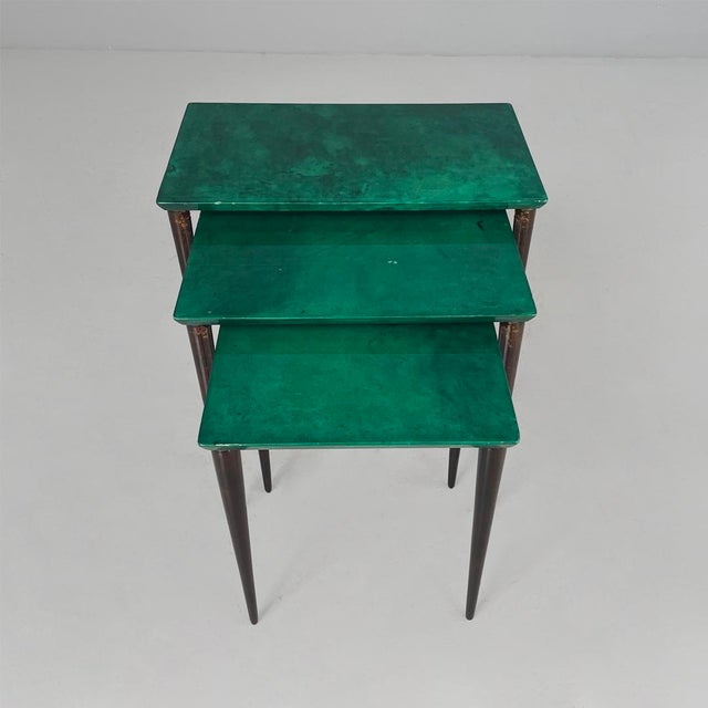 Italian mid-century modern wood and parchment, 1960s Set of three coffee tables made entirely of wood. The set consists of...