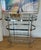 This stylish modern and sleek vintage bar cart features a heavy chrome construction with 3 thick clear glass oval shelves...